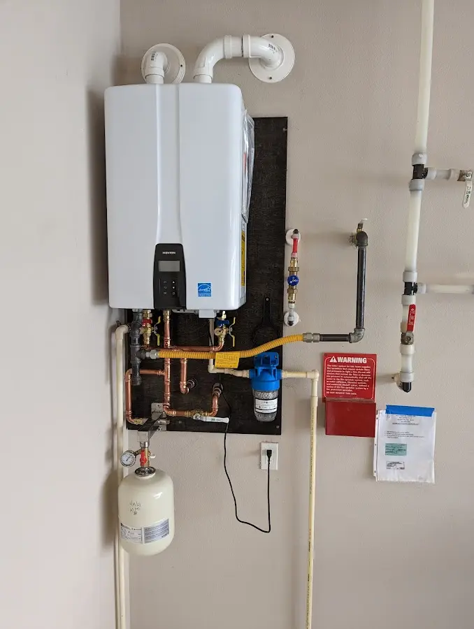 Professional plumber installing copper piping in a Kutztown home
